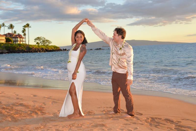 couple twirling on beach