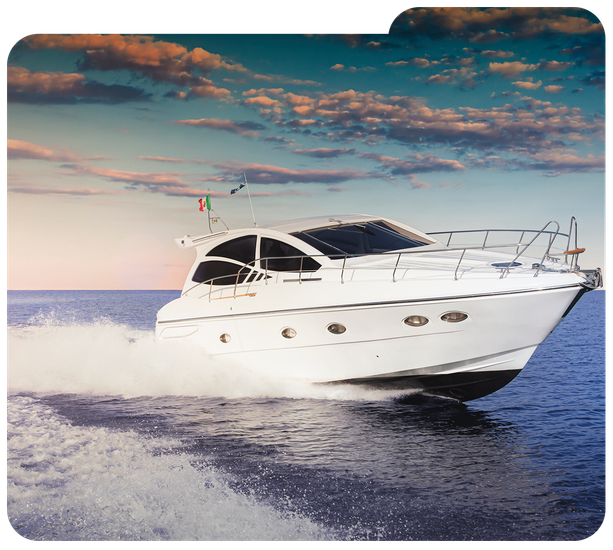 White luxury yacht speeding across calm blue water under a colorful sunset sky.