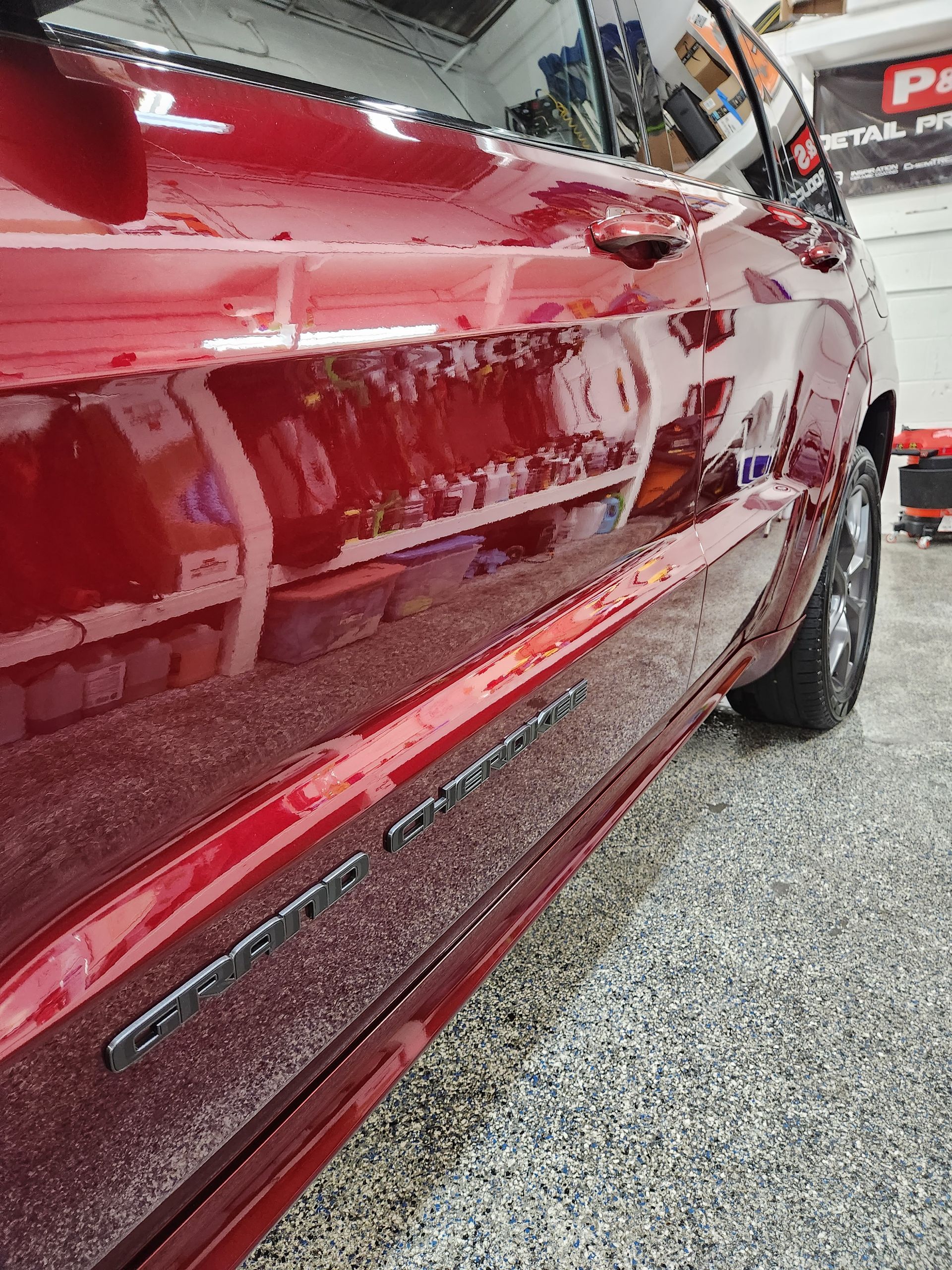 A red car is parked in a garage.