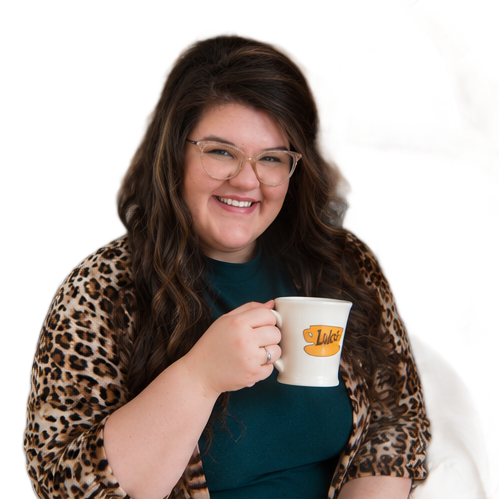 A woman wearing glasses and a watch is holding a cup of coffee