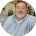 A man with a beard is smiling in a circle.