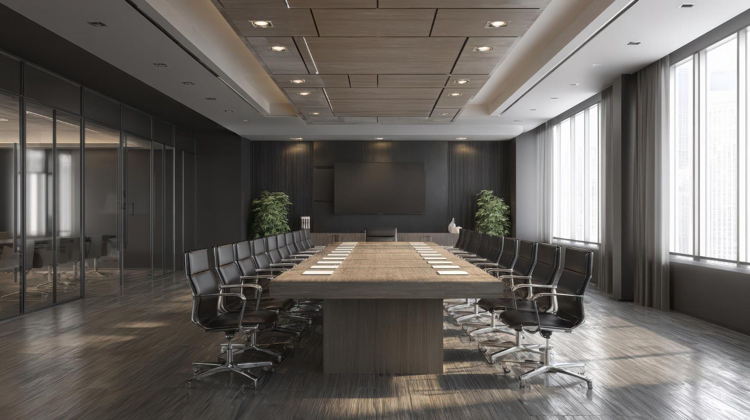 Modern conference room with long table, office chairs, and large windows along the right wall