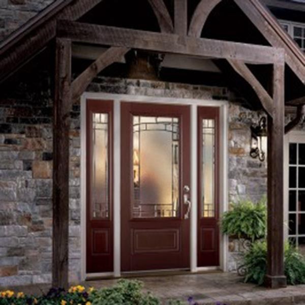 Rustic wooden porch with a red front door and sidelights beneath exposed beams