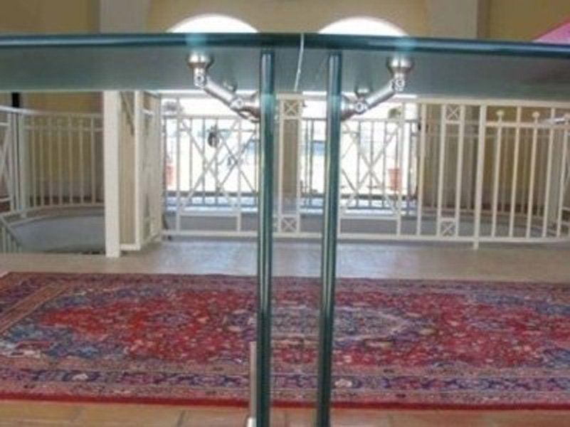 Un tavolo in una stanza con un tappeto e una ringhiera