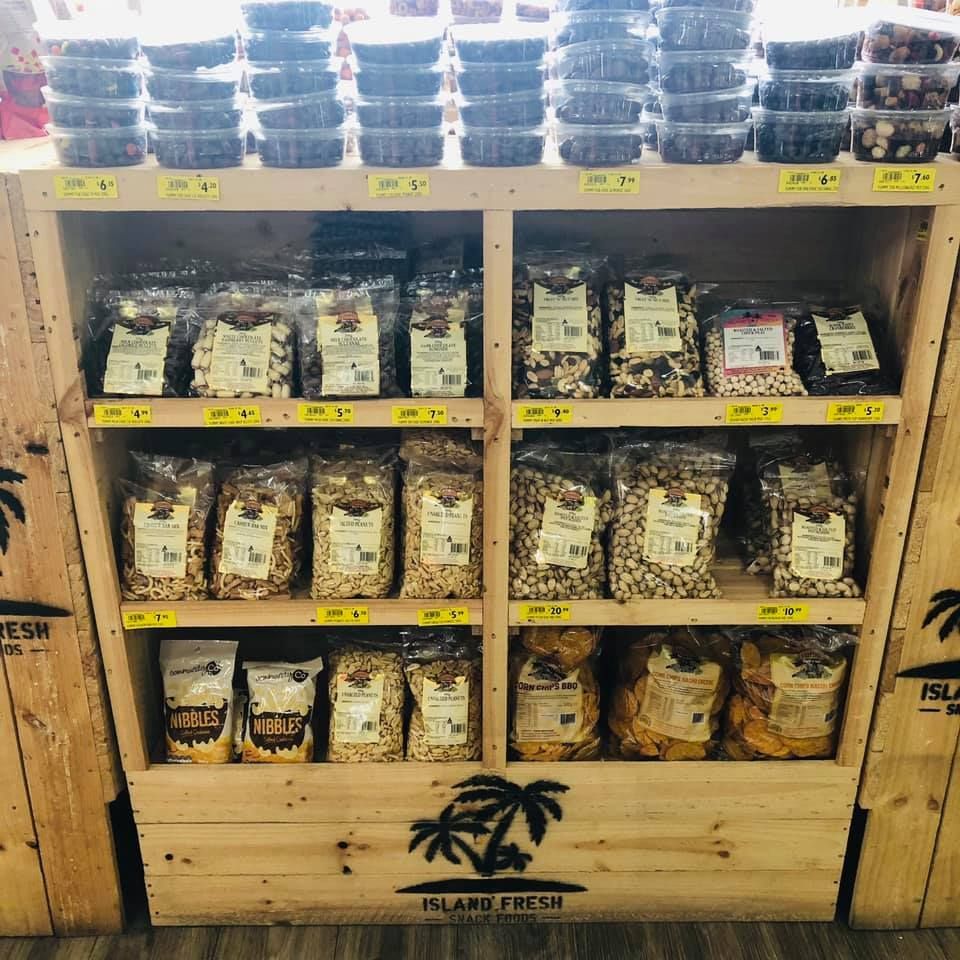 A wooden shelf filled with bags of food and a sign that says island fresh — Smith Street Supermarket In Darwin City, NT