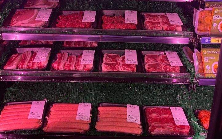 A variety of meats are displayed on a shelf in a butcher shop. — Smith Street Supermarket In Darwin City, NT
