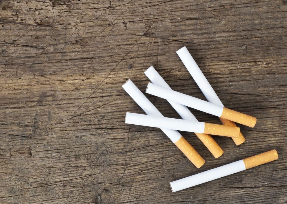 A Pile Of Cigarettes On A Wooden Table — Smith Street Supermarket In Darwin City, NT
