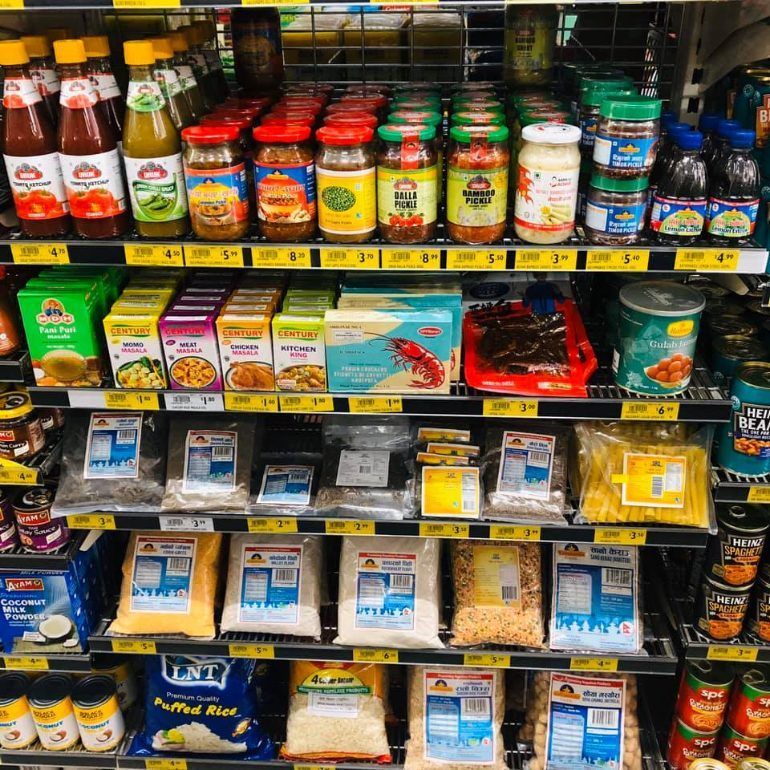 A grocery store aisle with a bag of puffed rice on the bottom shelf — Smith Street Supermarket In Darwin City, NT