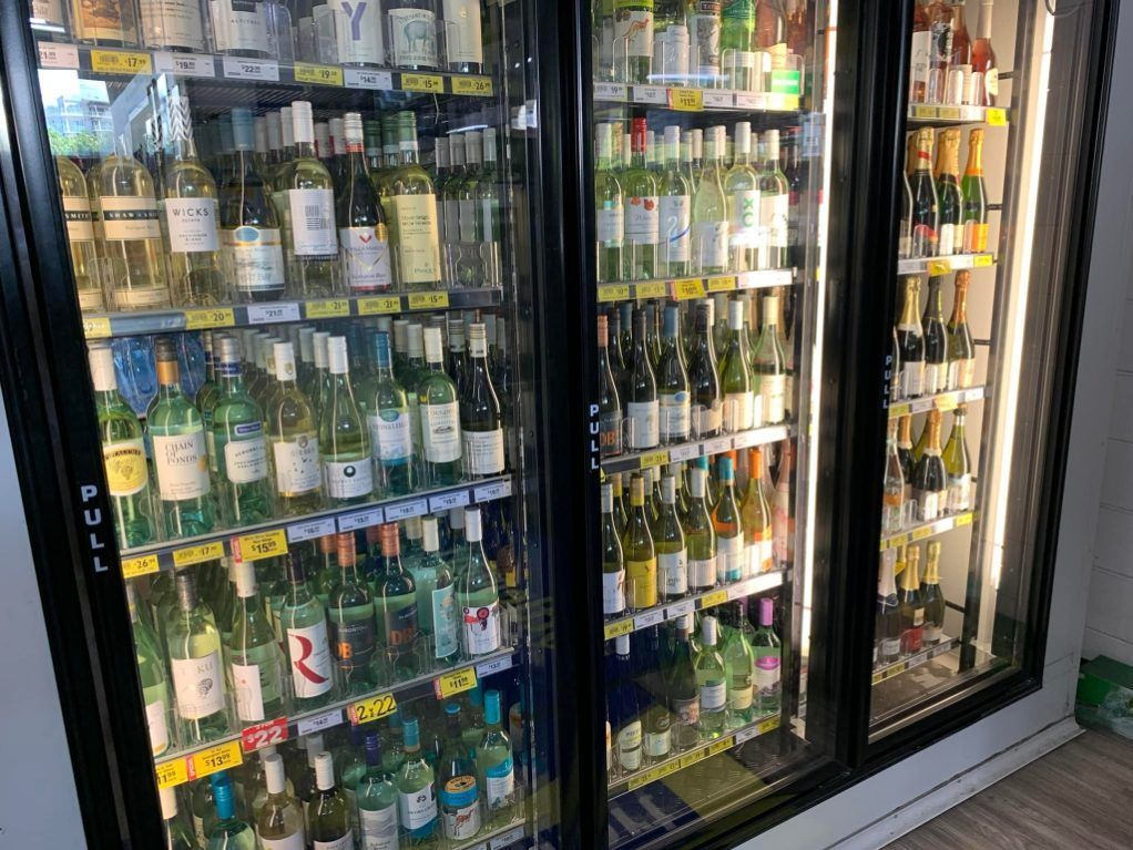 A Group Of People Are Toasting With Wine Glasses At A Party — Smith Street Supermarket In Darwin City, NT