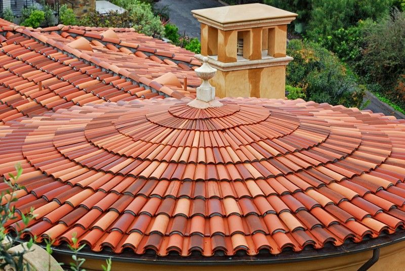 A row of light green clay tiles on a roof.