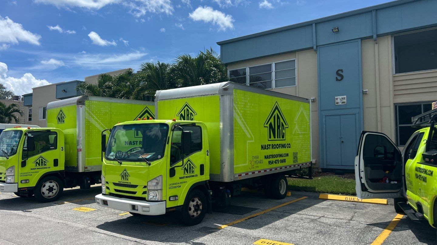 Nast Roofing Delivery Trucks parked outside job site