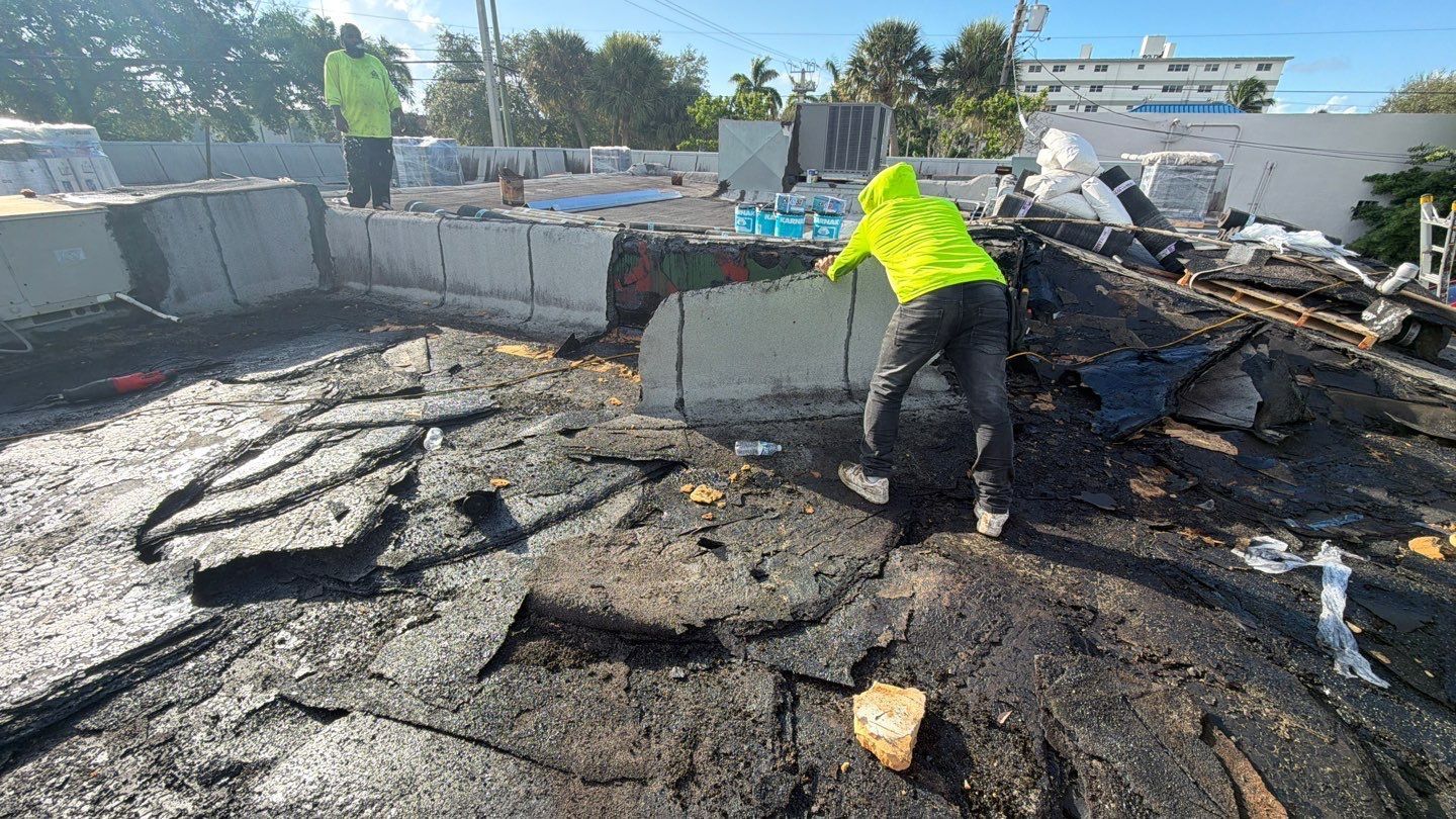 Nast Roofing professionals removing old asphalt roofing in Deerfield Beach FL
