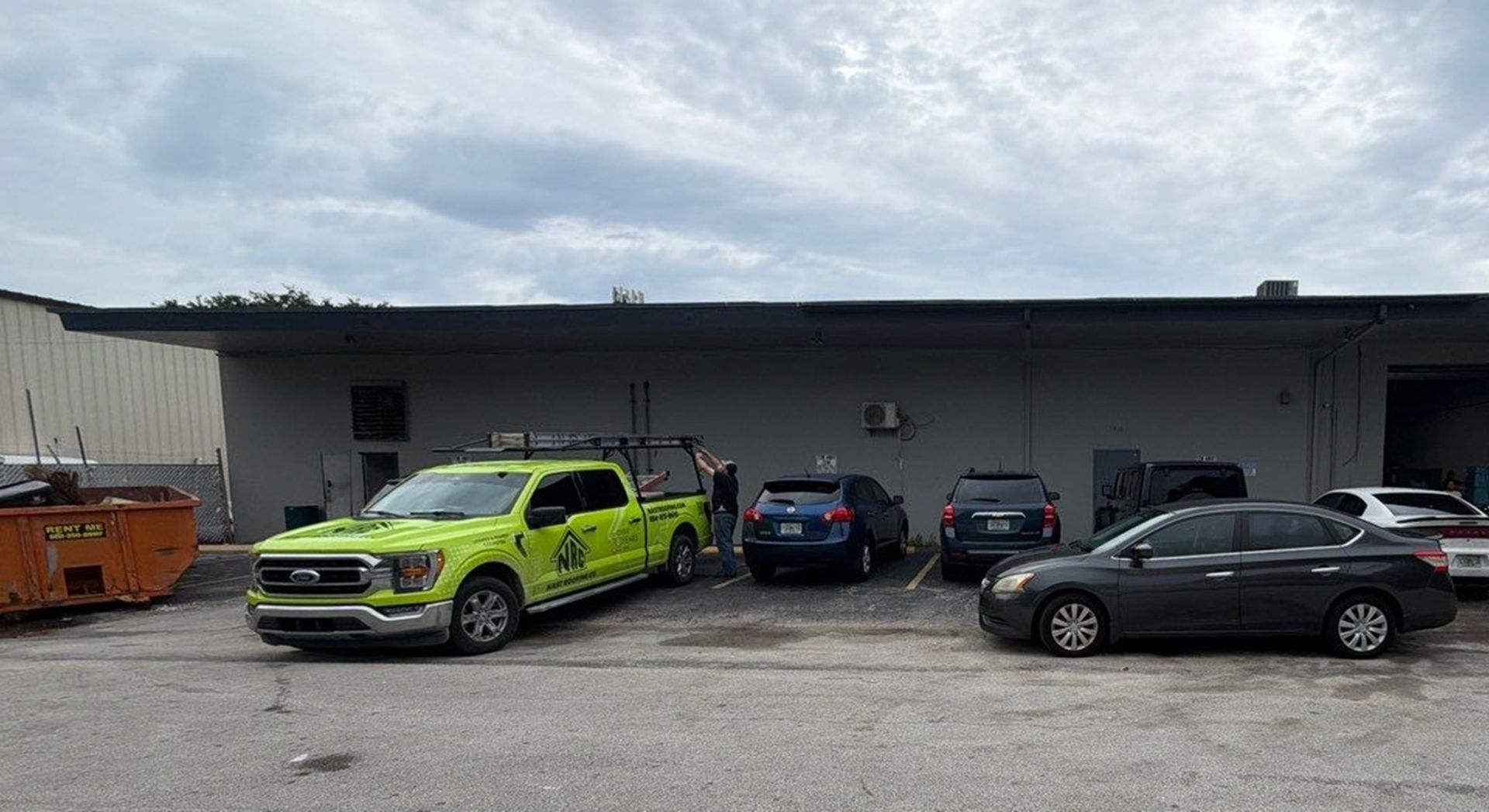 Nast Roofing Delivery Trucks parked outside job site