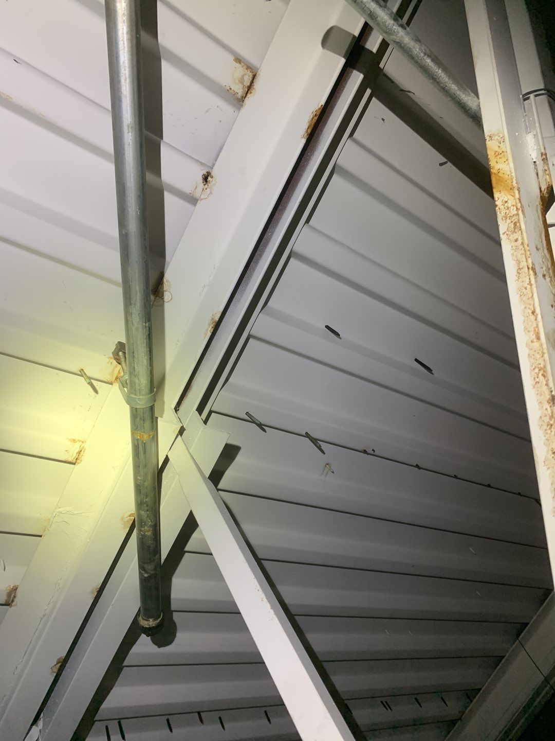 Steel beams inside commercial building showing rust and water damage due to roof leaks in Hallandale Beach Fl