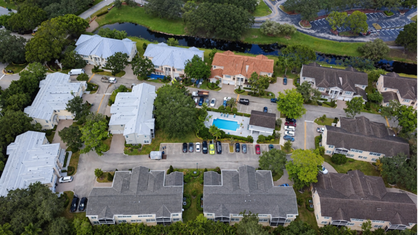 Aerial view of properties in South Florida with different types of roofs, metal, shingle and tile.