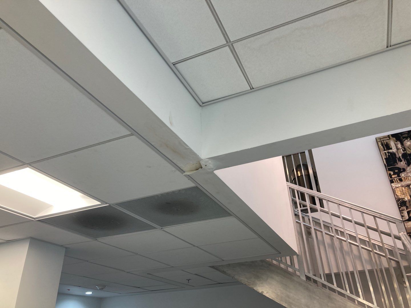 Water damage on ceiling in a commercial building office space due to roof leaks in Hallandale Beach FL