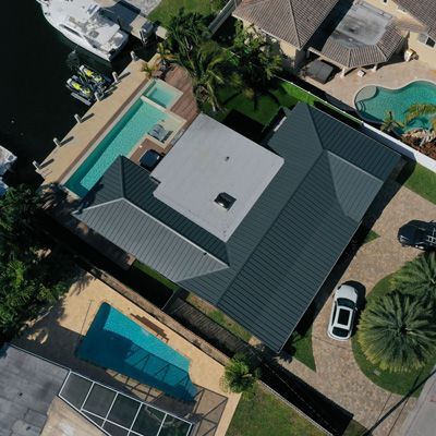 An aerial view of a house with a swimming pool