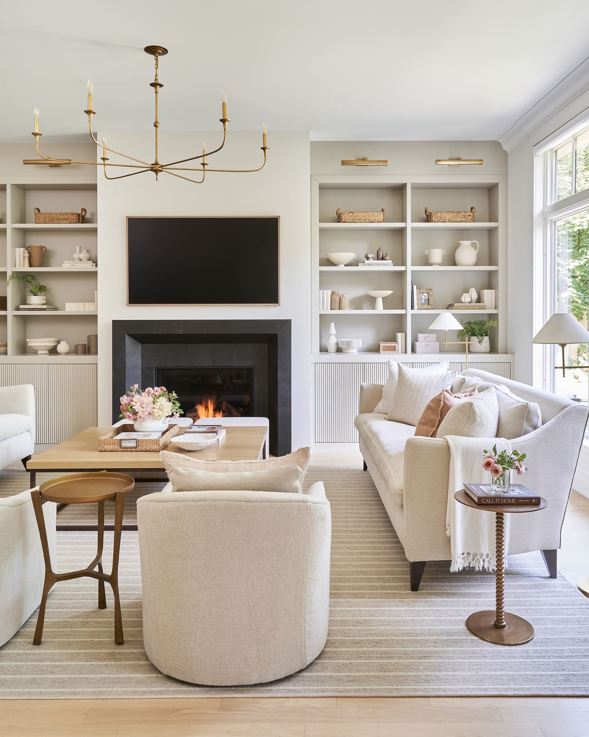 Cozy living room with fireplace, built-in shelves, and neutral-toned furniture.