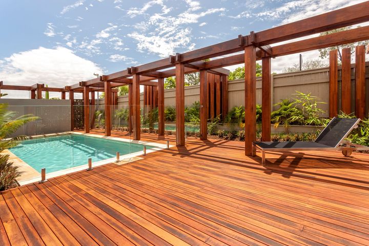 Modern brown composite deck with patio furniture.