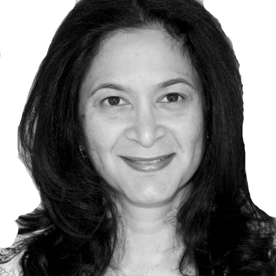 Black-and-white headshot of a smiling person with dark shoulder-length hair on a plain white background