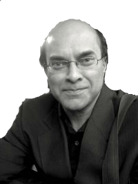 Black-and-white portrait of a smiling person wearing glasses and a dark jacket