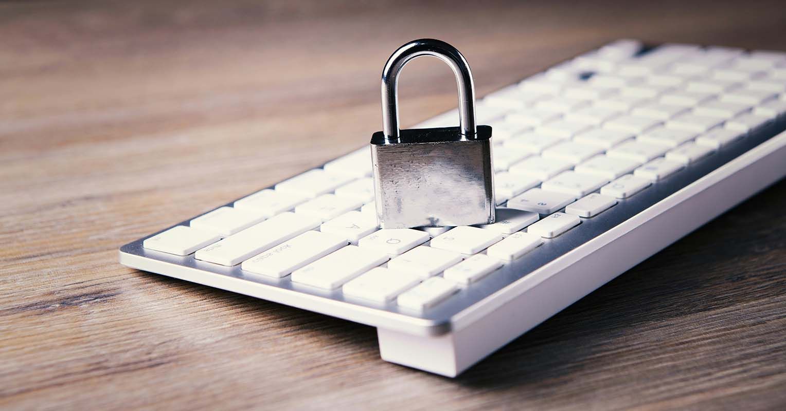 Padlock on a white keyboard, symbolizing computer security or restricted access