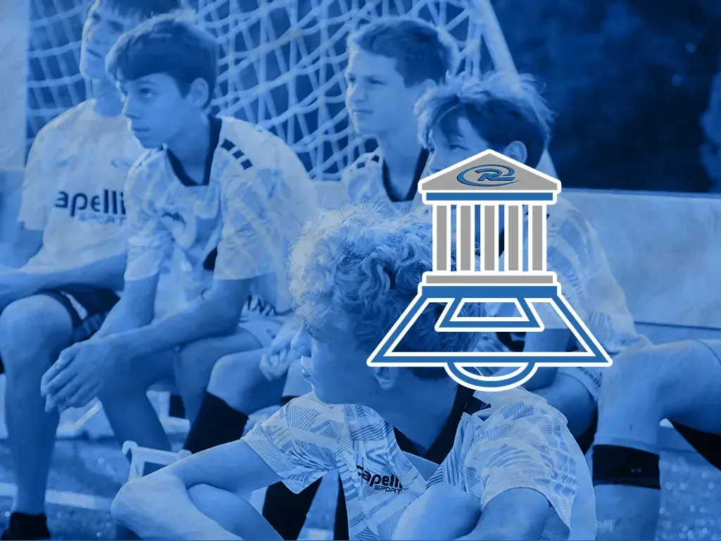 Soccer player in blue-and-black jersey smiling over a blue team collage and logo background