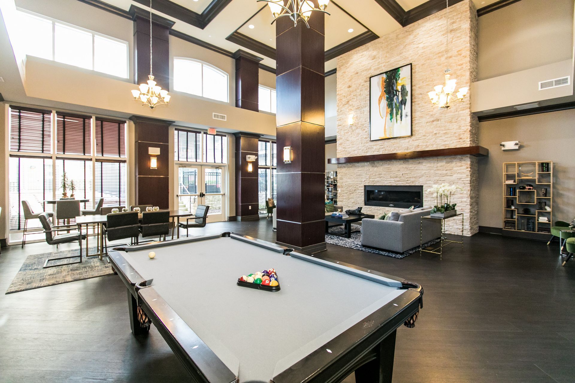 Clubhouse lounge with pool table, fireplace, and seating at Verde at Howard Square West Apartments in Elkridge, MD.