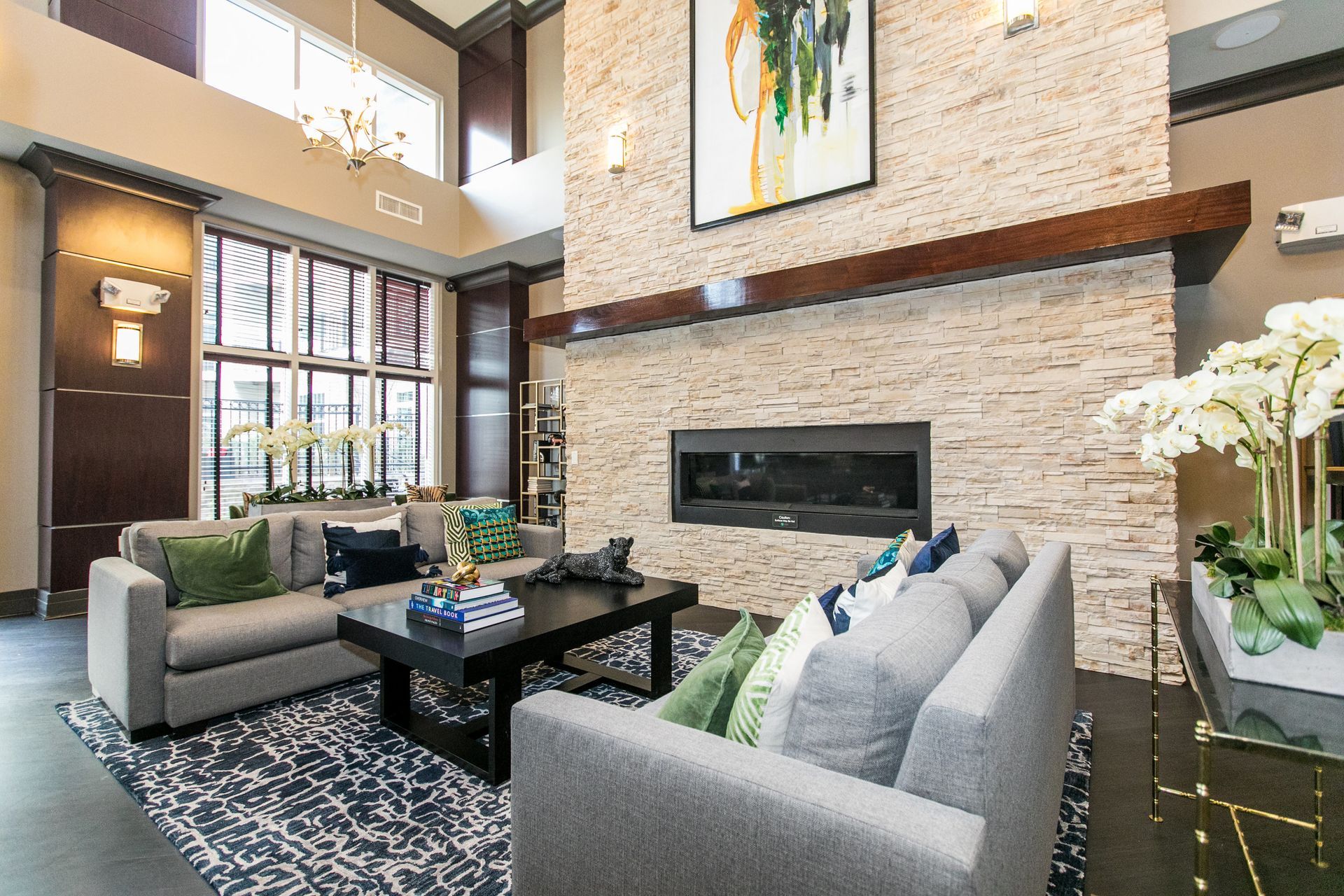 Clubhouse lounge with  fireplace, and seating at Verde at Howard Square West Apartments in Elkridge, MD.