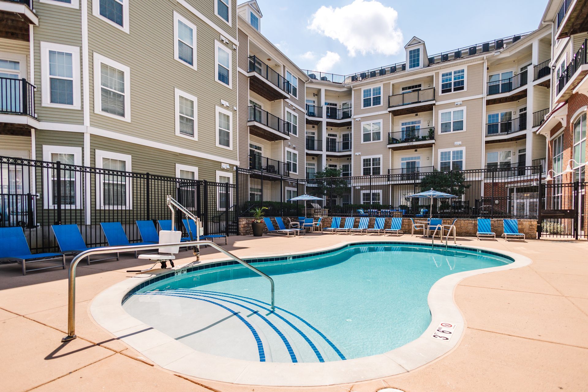 Swimming pool with lounge chairs at Verde at Howard Square West Apartments in Elkridge, MD.