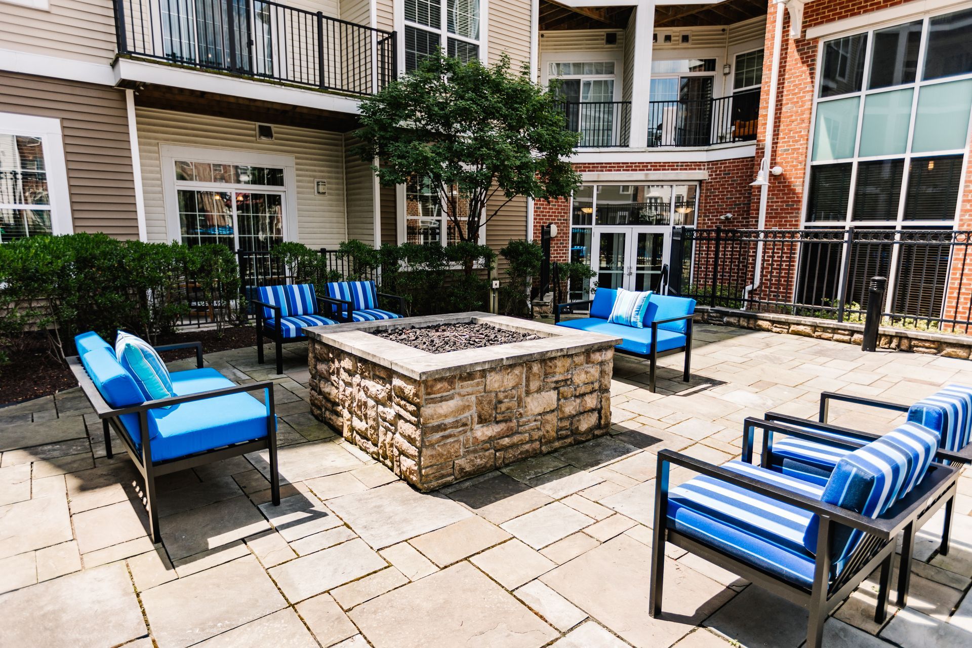 Outdoor courtyard with fire pit and seating at Verde at Howard Square West Apartments in Elkridge, MD.