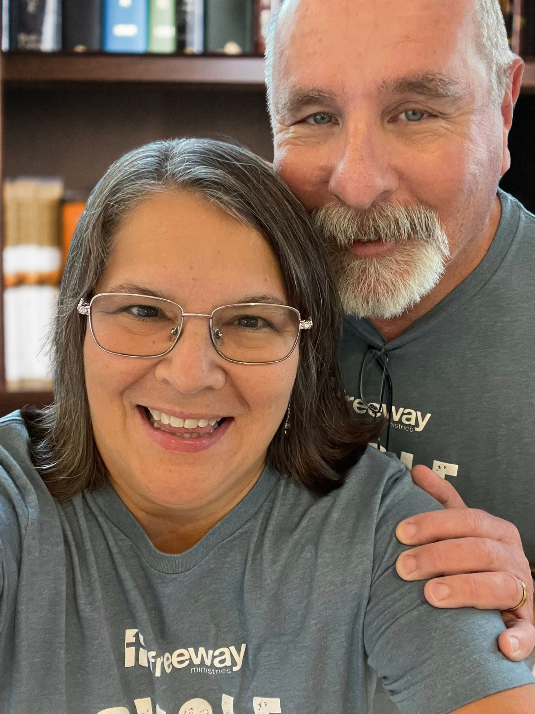 A man and a woman are posing for a picture.