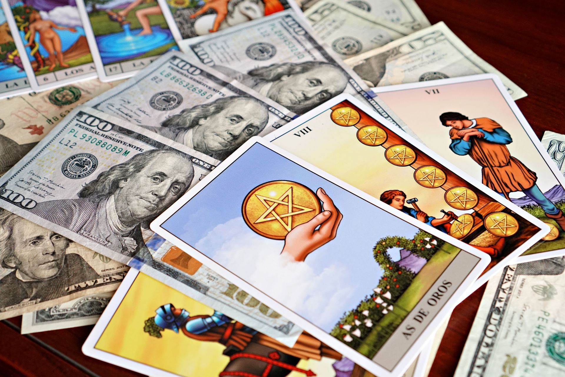 A person is playing tarot cards on a wooden table.