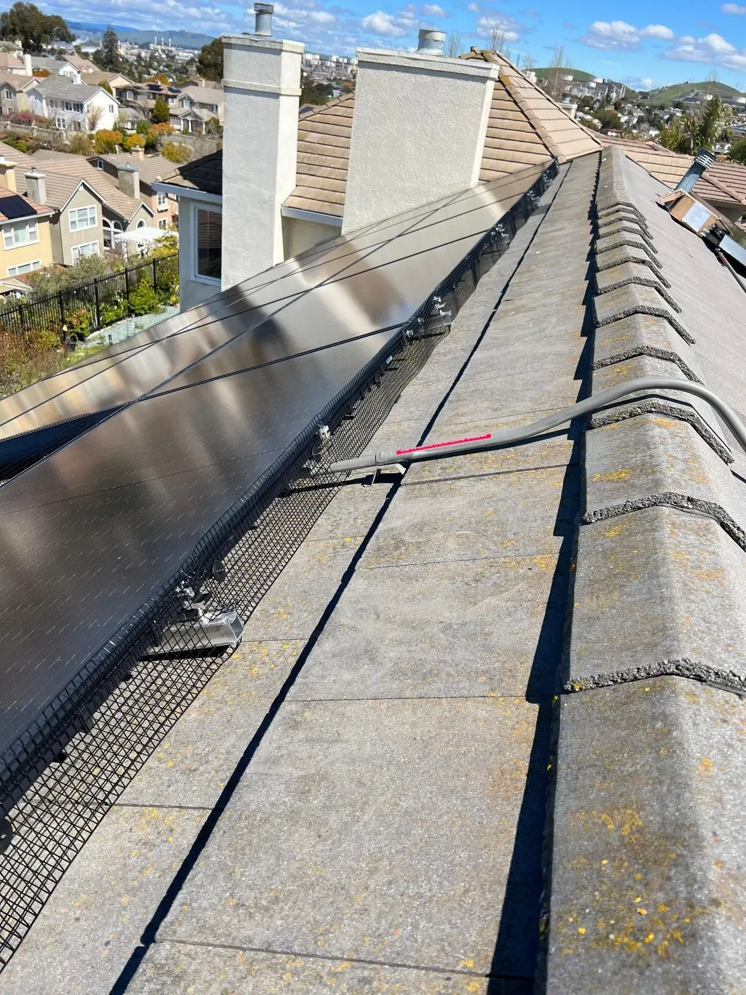 A close up of a roof with a chimney on it.