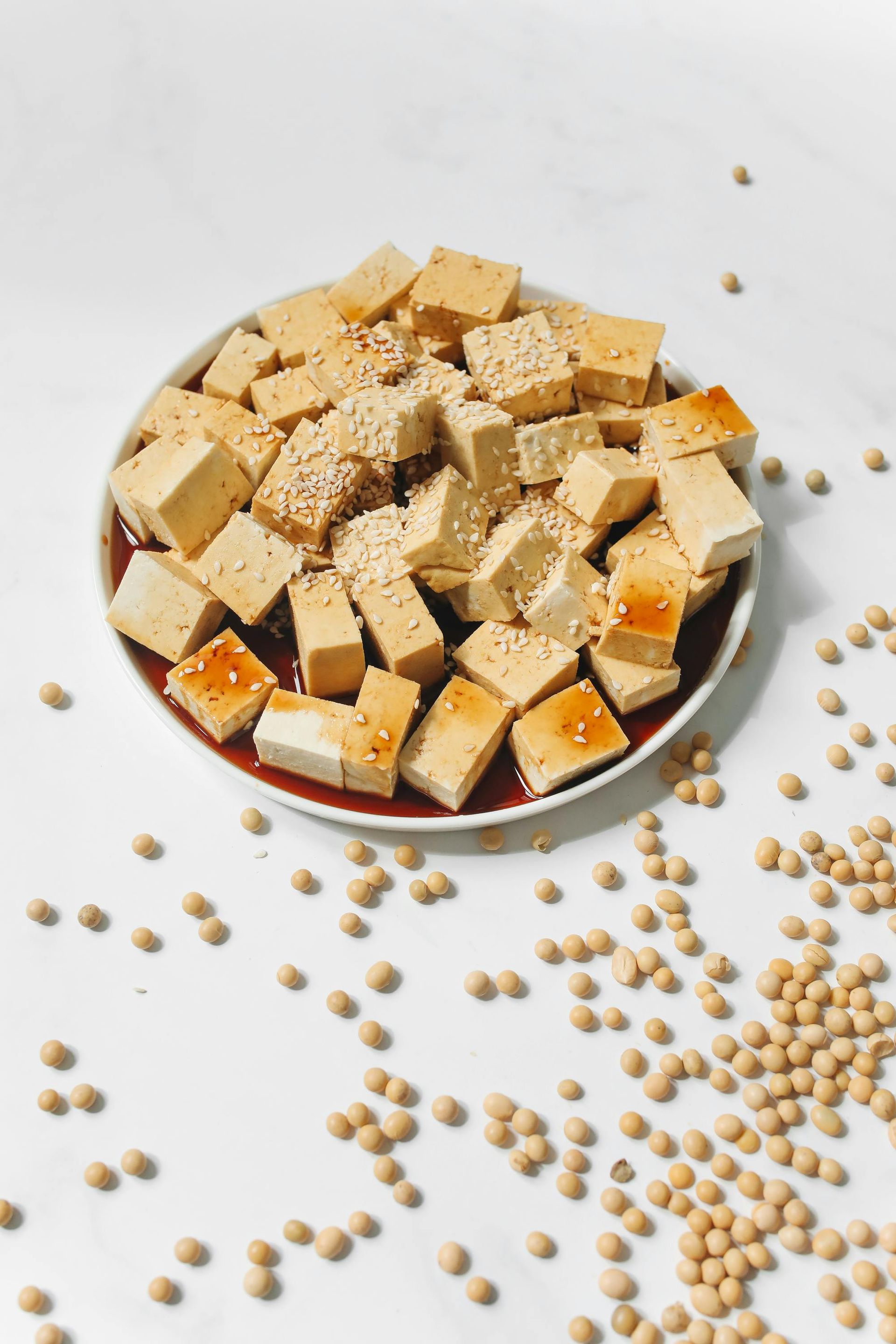 A plate of tofu and soybeans on a table.