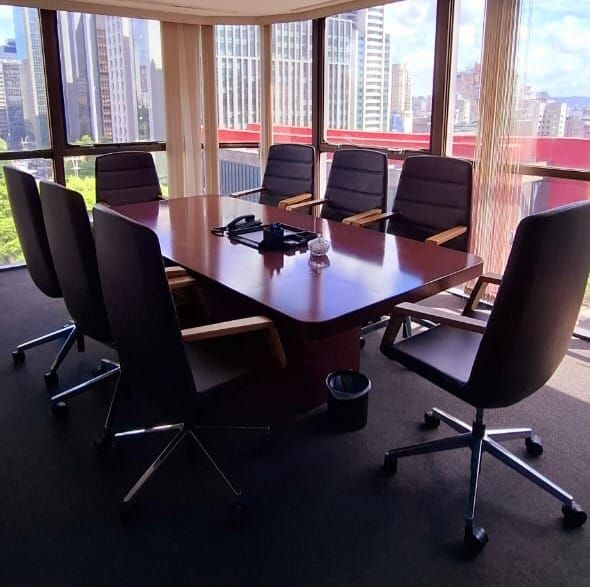 Sala de conferências com mesa grande e cadeiras