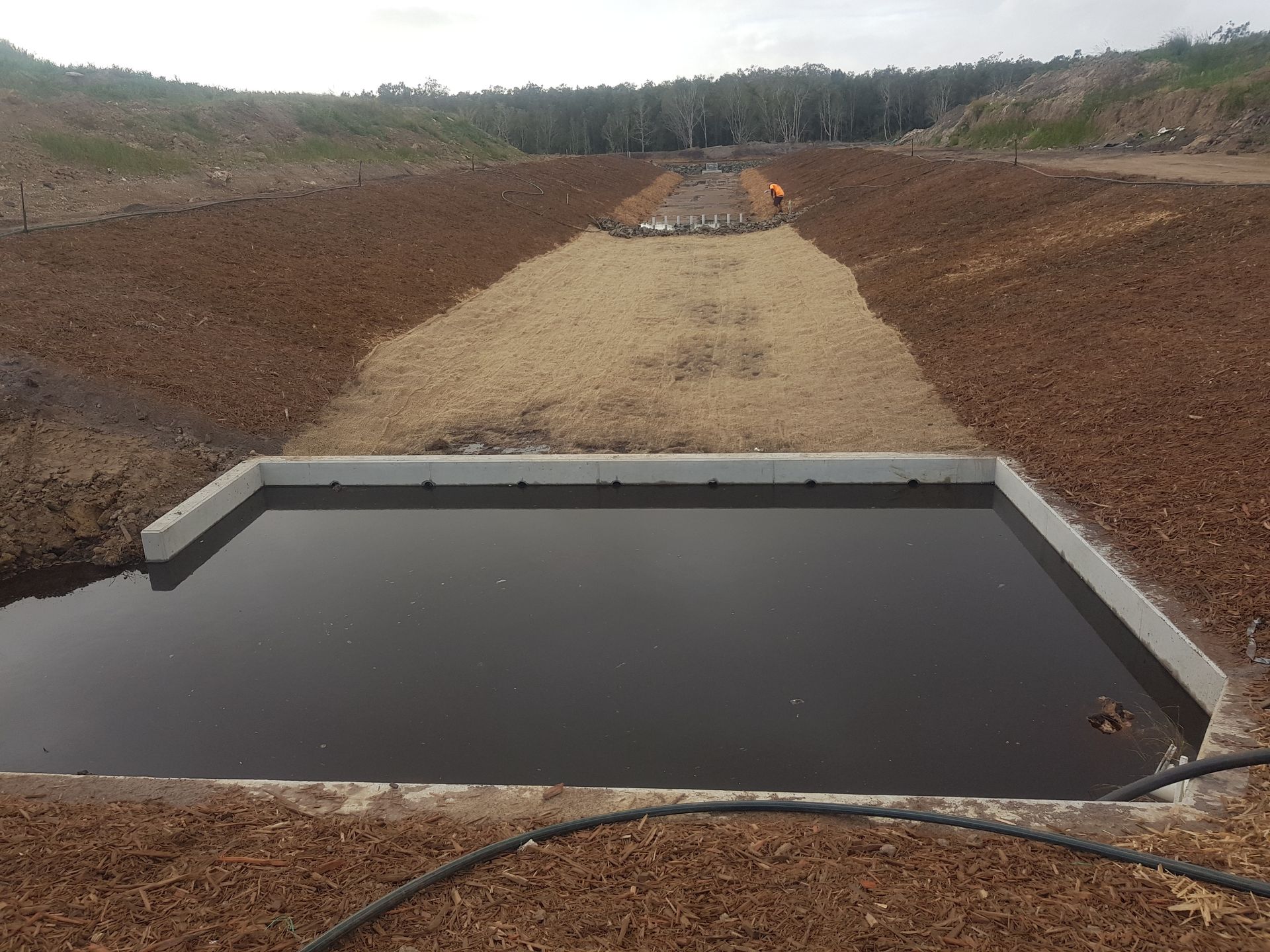 Concrete Basin Filled with Dark Water, Flanked by Dirt Banks — Snell Earthworx In Maryborough, QLD