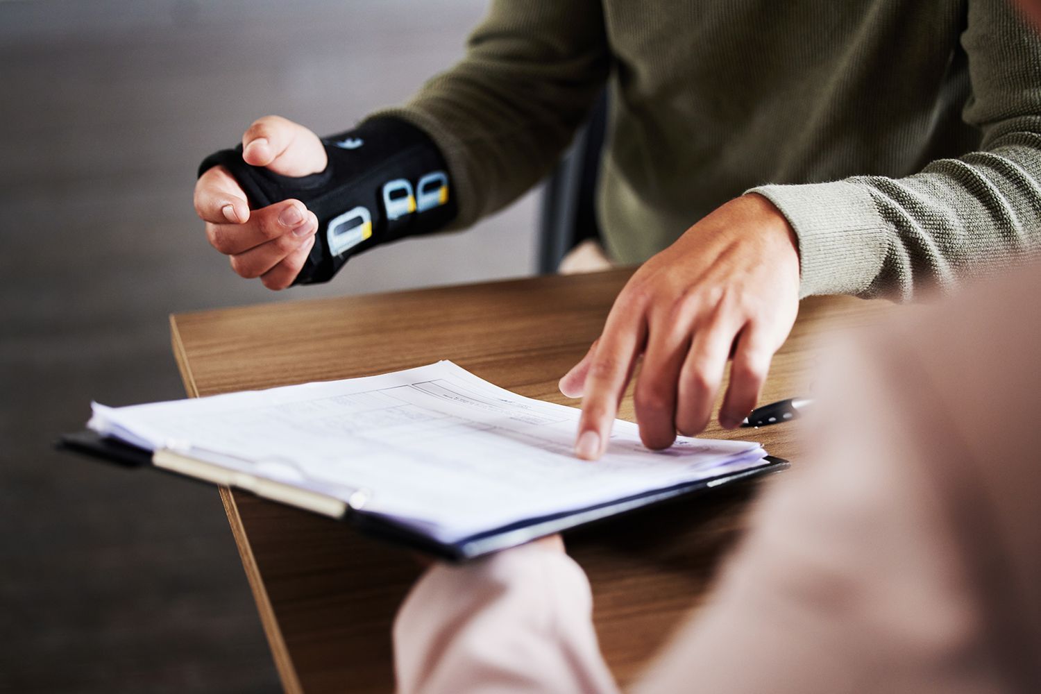 An injured man is reviewing a document.