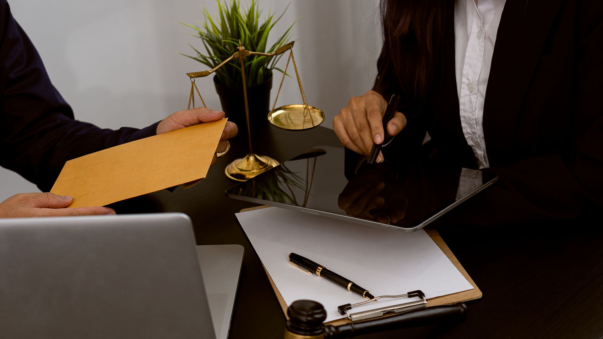 Lawyer consulting client with legal documents, scales of justice, and gavel on desk. Lawyer consulting client with legal documents, scales of justice, and gavel on desk.