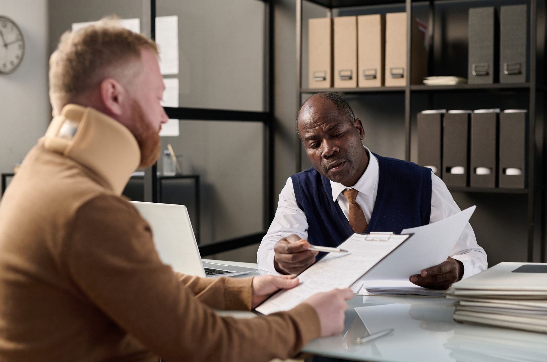 A neck brace man meets with a lawyer in a suit at Maxwell Law Firm, a personal injury attorney in Bamberg, SC. A neck brace man meets with a lawyer in a suit at Maxwell Law Firm, a personal injury attorney in
Bamberg, SC.