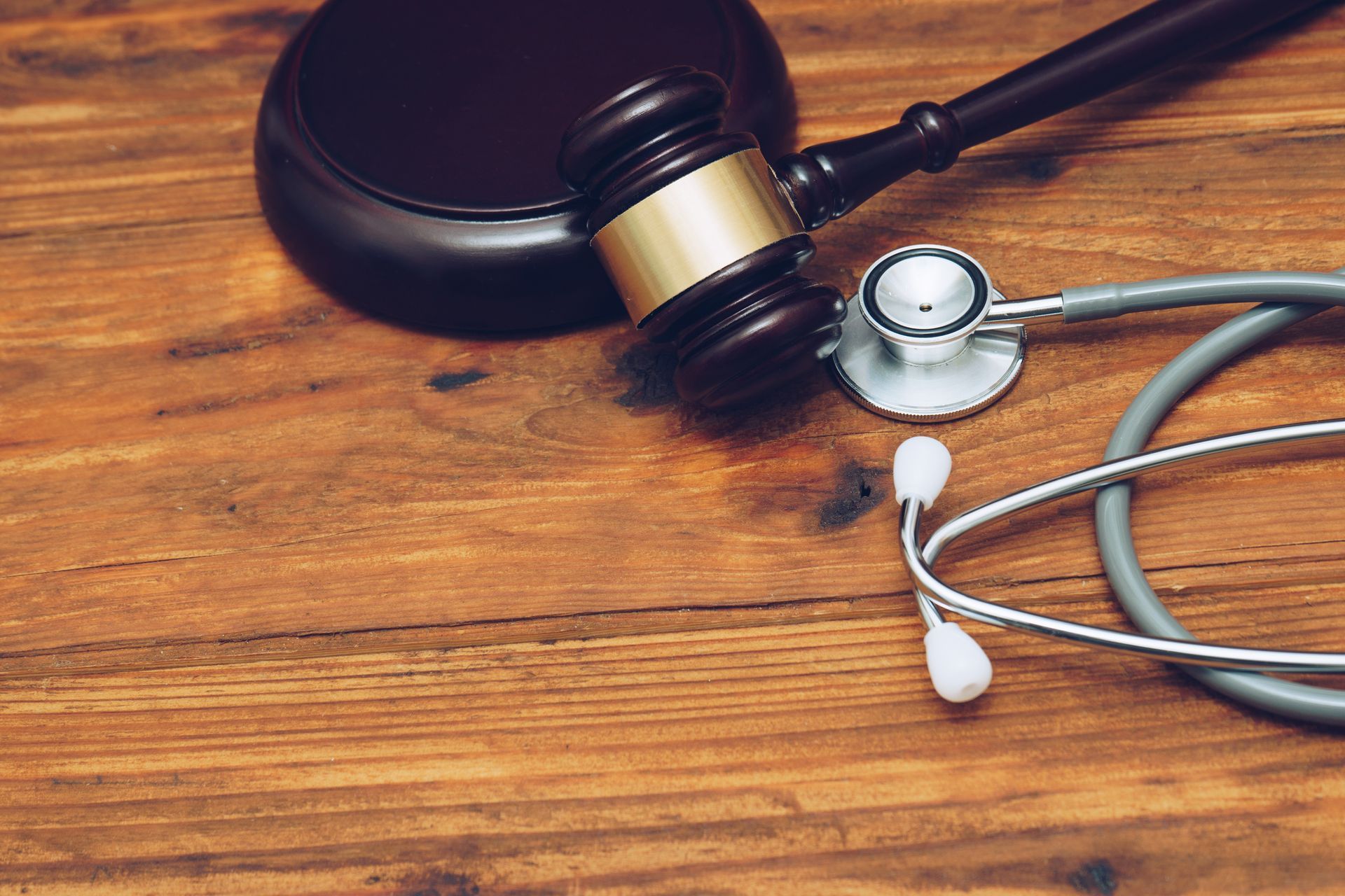 A gavel and a stethoscope on a table representing a Personal Injury Lawyer