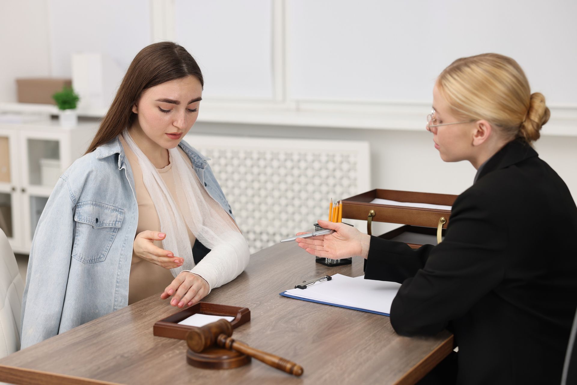 An injured woman is having a meeting with a lawyer in the office.