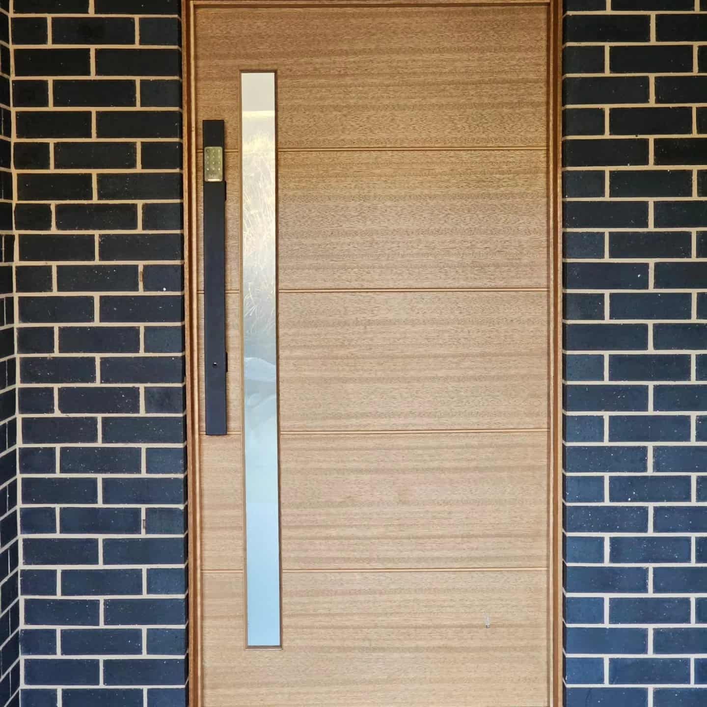 A Wooden Door With A Stainless Steel — Border Security Doors & Powder Coating in Wodonga, VIC