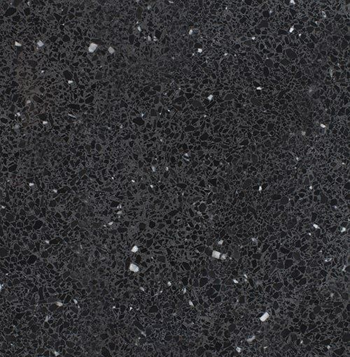 A close up of a black granite counter top with white spots.
