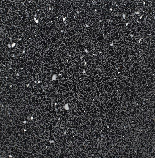 A close up of a black surface with white dots on it.