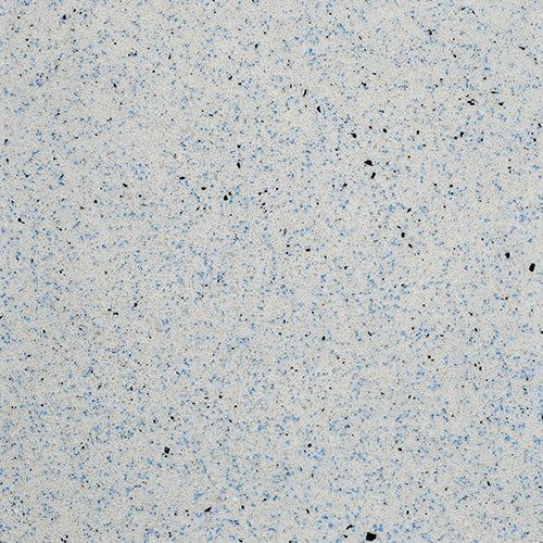 A close up of a white surface with blue spots
