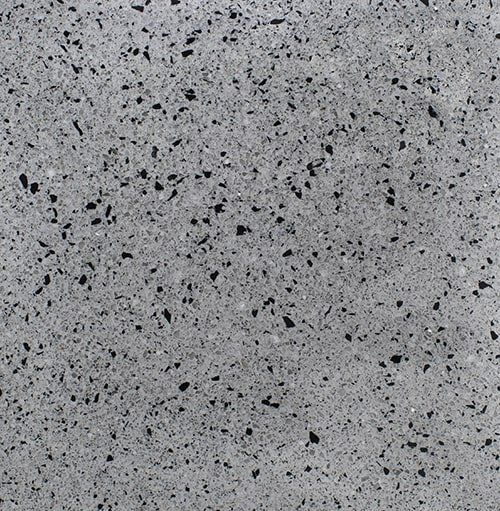 A close up of a gray and black granite counter top.