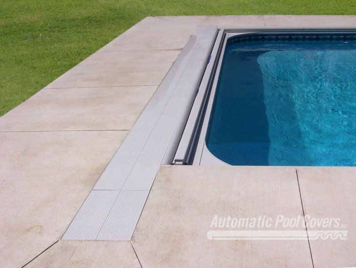 A swimming pool with automatic pool covers installed