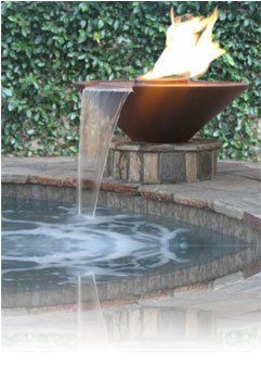 A water fountain with a flame in the middle of it