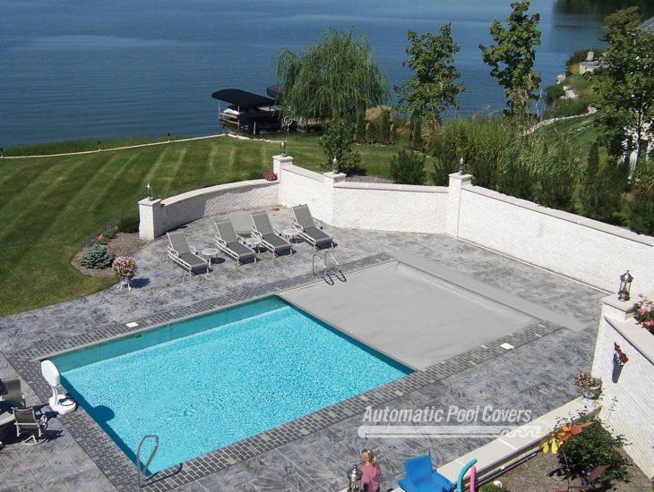 An aerial view of a large swimming pool with automatic pool covers